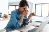 tired woman working at her computer